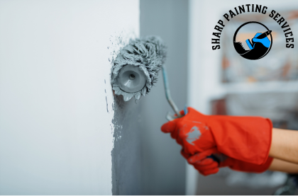 Showcasing House Painting Services in Sydney, with a paint brush painting a wall with gray colour
